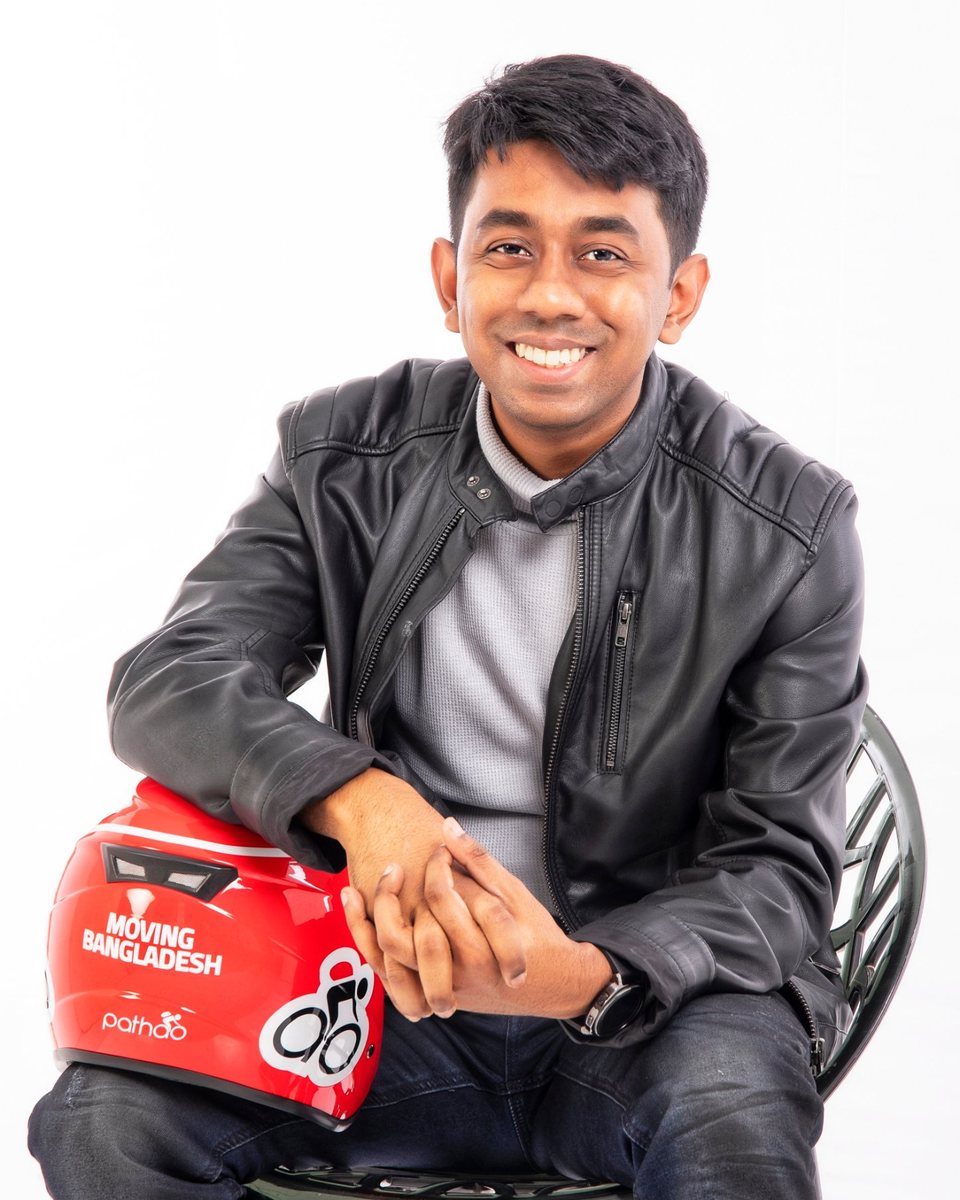 Hussain M. Elius, seated, holding a red Pathao helmet